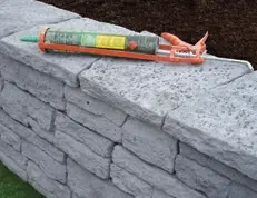22995 09 9. Place capping stones on